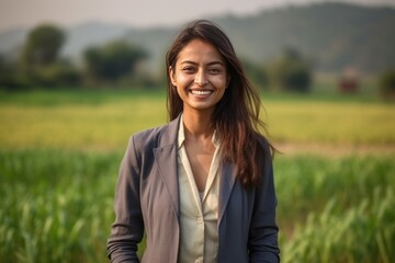 Medium shot portrait of an Indian woman in her 30s wearing a classic blazer in an indian rural landscape 
