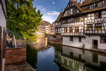 Strasbourg, France - June 19, 2023: Traditional half-timbered houses on the picturesque canals of La Petite France in the medieval town of Strasbourg, UNESCO World Heritage Site, Alsace, France