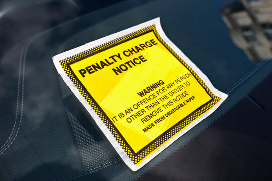Penalty charge notice parking fine attached to windscreen