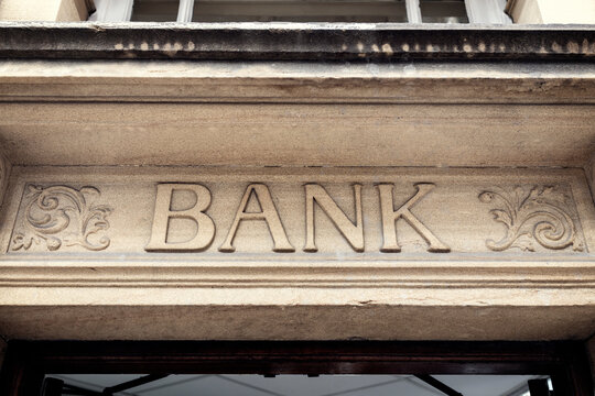 Bank sign above building entrance doorway