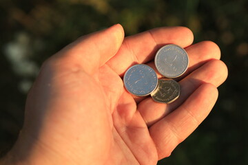 United Arab Emirates coins in hand