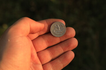 Coin quarter dollar in hand