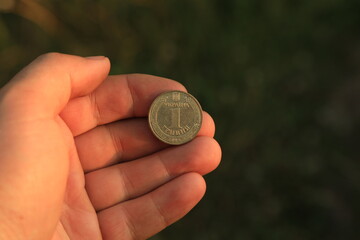 Modern Ukrainian coin in hand