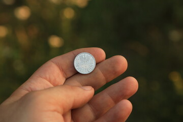 Old coin ten groschen in hand