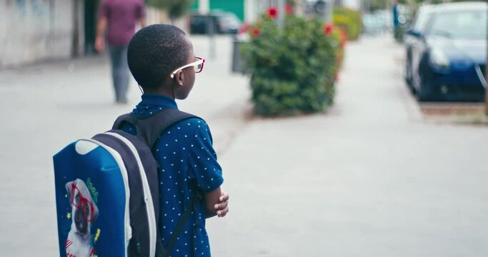 Young boy going at school alone 