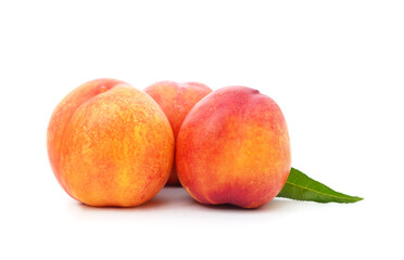 Three ripe peaches with leaves.