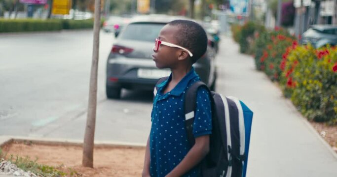 Young boy going at school alone 