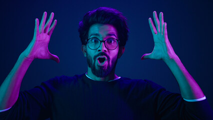 Male portrait neon ultraviolet background Arabian man Indian guy coder hacker showing head mind...