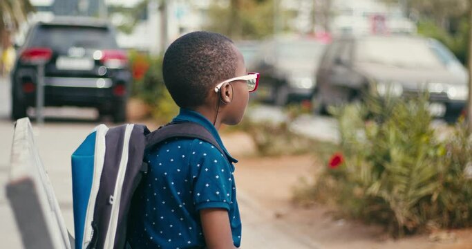 Young boy going at school alone 