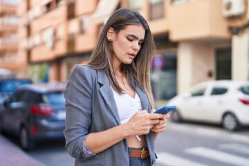 Young woman using smartphone at street