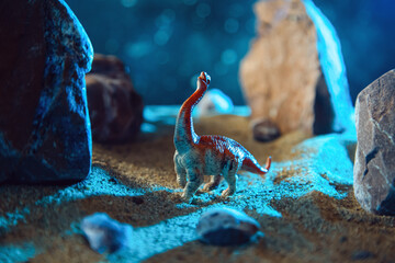 Dinosaur in a rocky gorge at night. © lizavetta