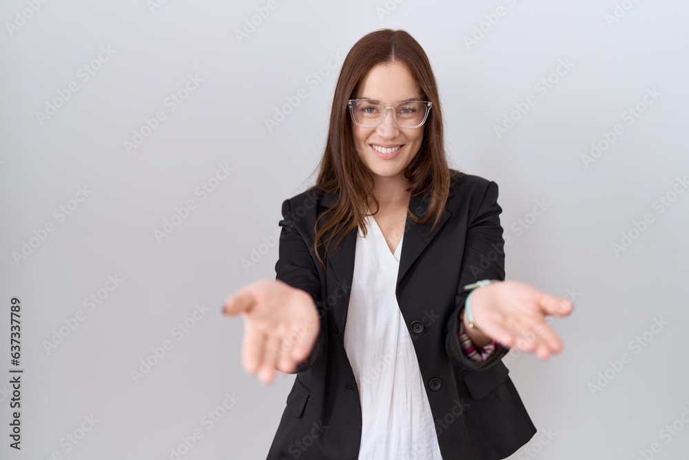 Poster beautiful brunette woman wearing business jacket and glasses smiling cheerful offering hands giving 