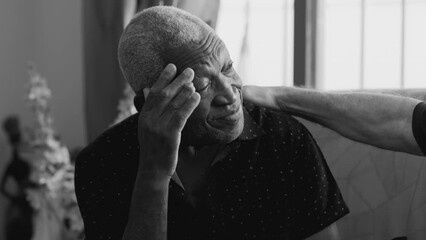 Senior Black Man Seeking Comfort and Support from Friend During Difficult Times. Elderly person suffering from depression and metal illness in monochrome black and white