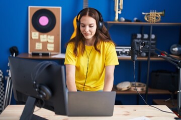 Young woman musician having dj session at music studio