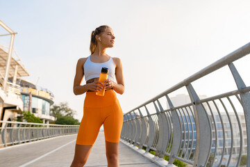 pretty young smiling woman doing sports in the morning in stylish sport outfit sportswear, skinny strong body, healthy fit lifestyle