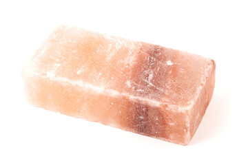 Himalayan salt stone block, crystal of natural pink salt isolated on white background