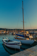A view at sunset from the quayside in the harbour in the town of Izola, Slovenia in summertime