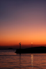 Fototapeta na wymiar Silhouette of town Primosten, Croatia, illuminated by beautiful sunset light.