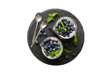 Healthy breakfast or morning with chia seeds vanilla pudding and blueberry berries on table background, vegetarian food, diet and health concept. Chia pudding with coconut milk and blueberry