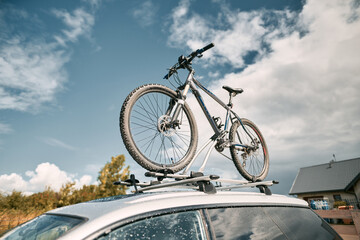 car is transporting bicycles on the roof. roof mount for carrying bikes and baggage. Family car for adventures