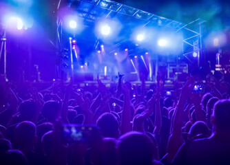 Crowd raising their hands and enjoying great festival party or concert.