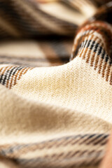Soft checkered woolen cloth, fashion industry, cozy blanket in warm tones - 637363781