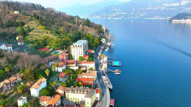 Aerial Forward Shot Of Town Near Lake Como And Mountain Ranges - Menaggio, Italy