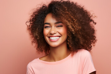 Beautiful woman with afro hair smiling on bright pink background, smiling portrait
