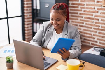 African american woman business worker using laptop and touchpad at office