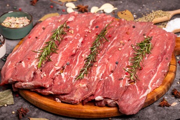 Large piece of beef fillet. Raw fillet meat on dark background. Butcher products. Close up