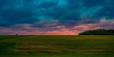 Foto op Canvas Dramatic stormy sunset hilly roadside landscape on the TranceCanada Highway of Route 2 at Springhill in Prince Edward Island, Canada © Naya Na
