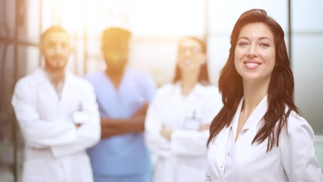 medic woman stands with her back and instructs with colleagues