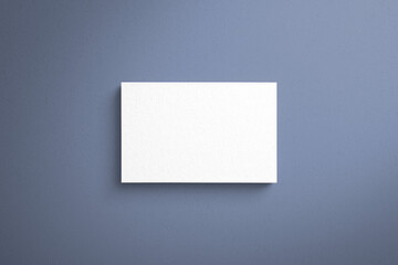 Mock-up of name card made of paper material with blue background