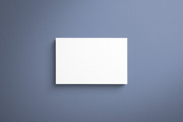 Mock-up of name card made of paper material with blue background