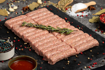 Raw beef patties. Fresh raw beef meatballs on dark background. Butcher products. Local name inegol...