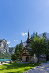 Fototapeta na wymiar Lake Braies (or Lago di Braies) church lake famous lake in Dolomites Alps Italy Europe extra wide panorama