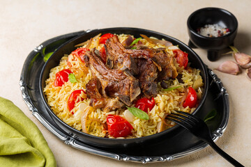 Plate with slow roasted lamb meat with saffron long rice and vegetables, onion, tomatoes, almond, basil leaves. Haneeth, pilaf, Mansaf, shanks or kabsa. Oriental food, light beige background.