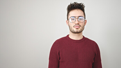 Young hispanic man standing with serious expression over isolated white background