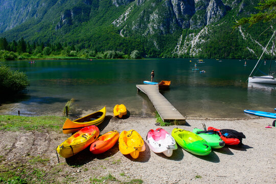 Bohinj Lake with boats, kayaks and canoes. People practicing water sports, Triglav National Park, Julian Alps, Slovenia - Powered by Adobe