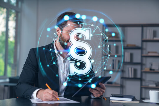 Considered businessman in formal wear signing contract holding tablet device at office room with papers. Concept of successful business deal, agreement, partnership, documents. Legal and law icons.