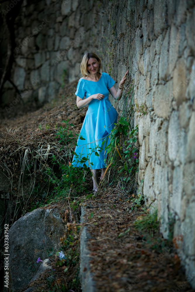 Sticker A woman in a blue dress wanders among medieval ruins.