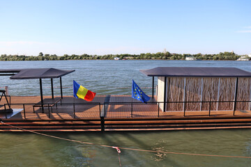 rustic pontoon bridge with romania and european union  flags