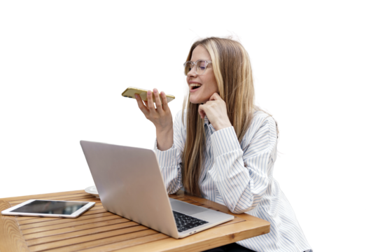 A young woman working uses a laptop and sends a voice message to her phone.  An office employee smiles and communicates online. Transparent background, png.