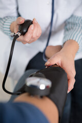 hand checking blood pressure stethoscope