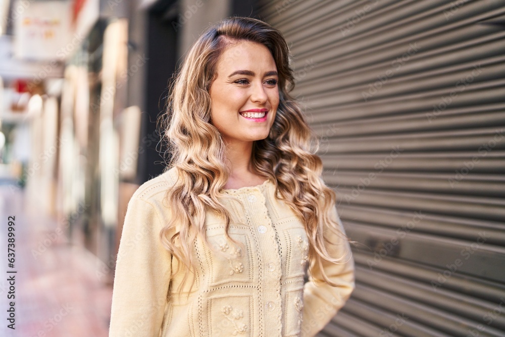 Poster Young woman smiling confident looking to the side at street