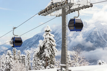 New modern spacious big cabin ski lift gondola against snowcapped forest tree and mountain peaks...