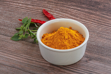 Yellow vibrant curcuma powder in the bowl