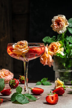 pink wine with strawberries in glasses, vertical image. top view. place for text