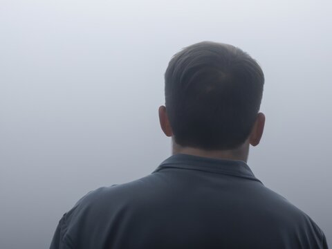 Mysterious man waiting in the fog