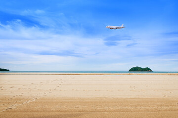 Commercial airplane above sea in summer season and clear blue sky over beautiful scenery sandy beach background, Concept business travel and transportation summer vacation travel.